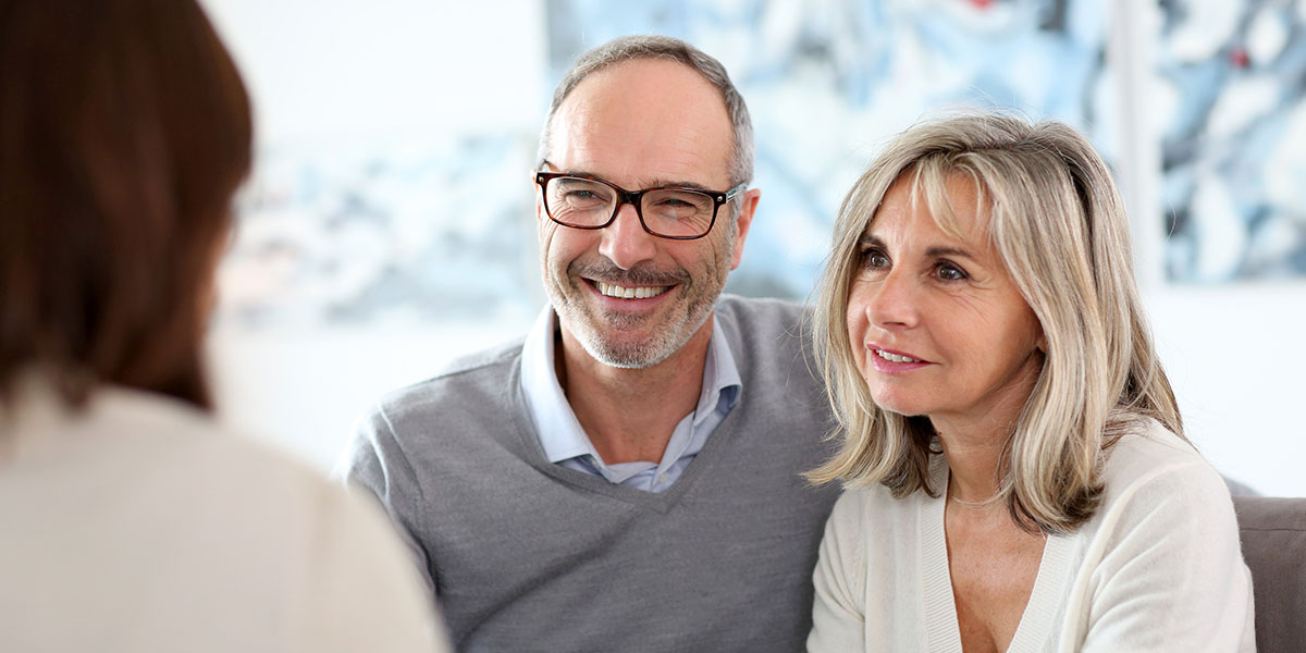 Senior couple meeting financial adviser for investment